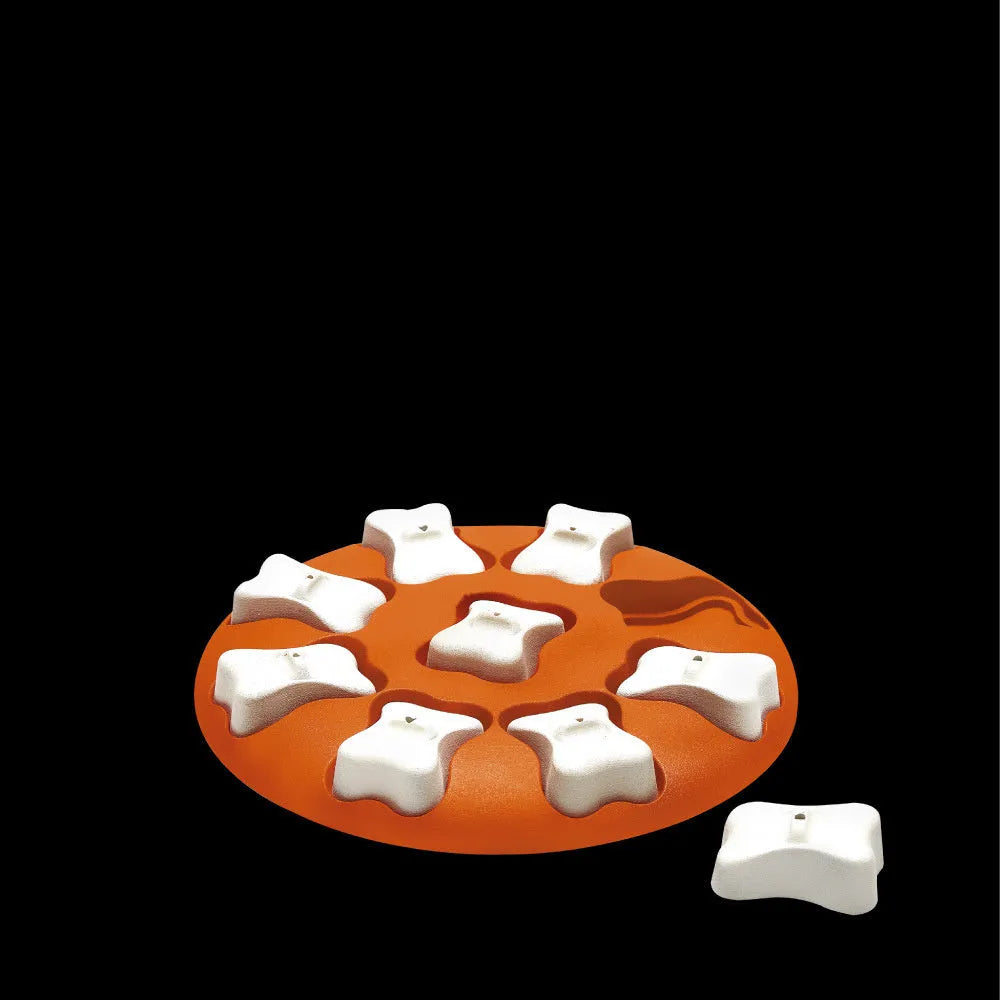 Orange and white plastic leak food toy for dogs and cats, puzzle feeder on surface