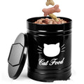 Round black iron sheet storage canister with lid on a kitchen shelf next to a white version.