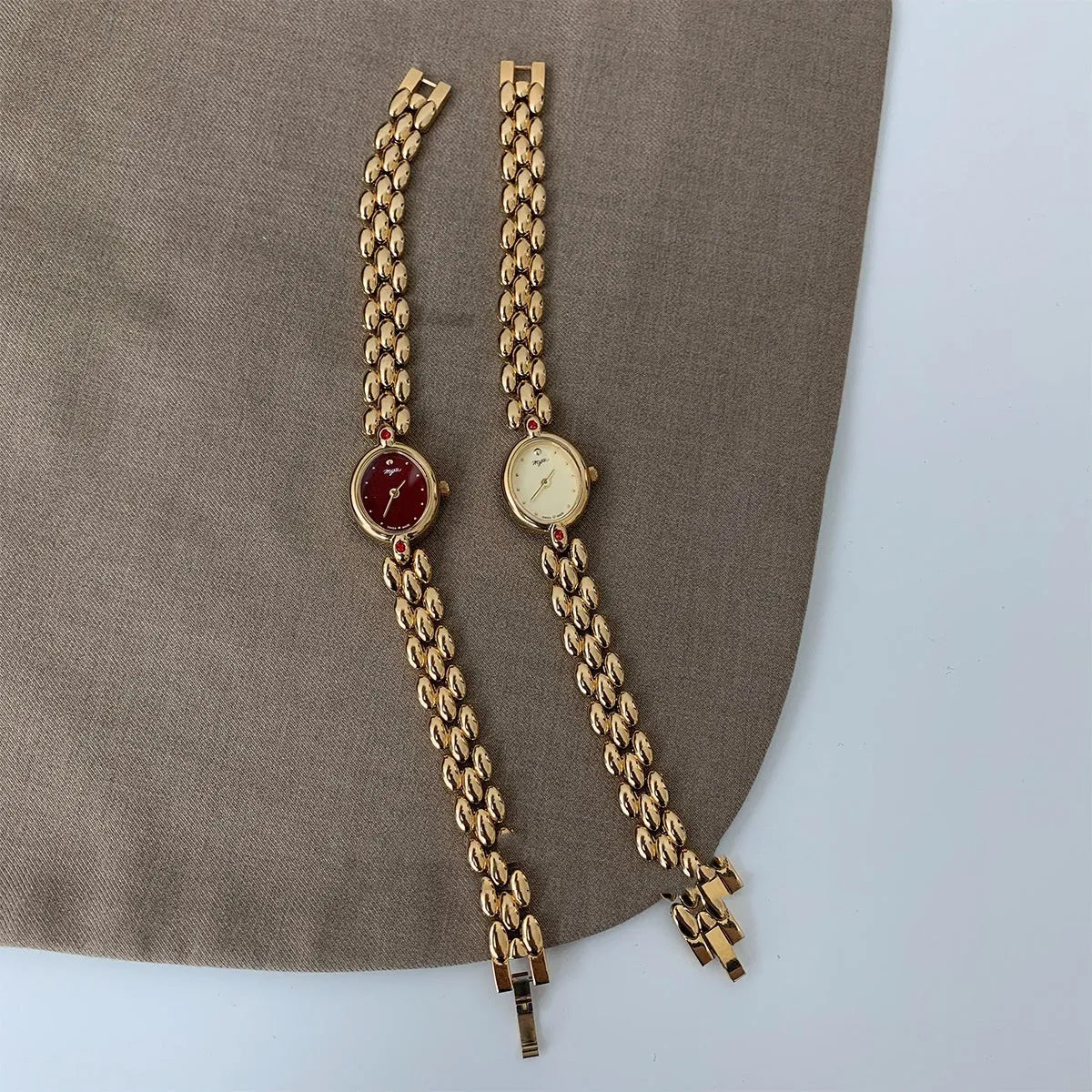 Retro oval small dial women's watch with gold alloy strap, shown in red dial and gold dial options