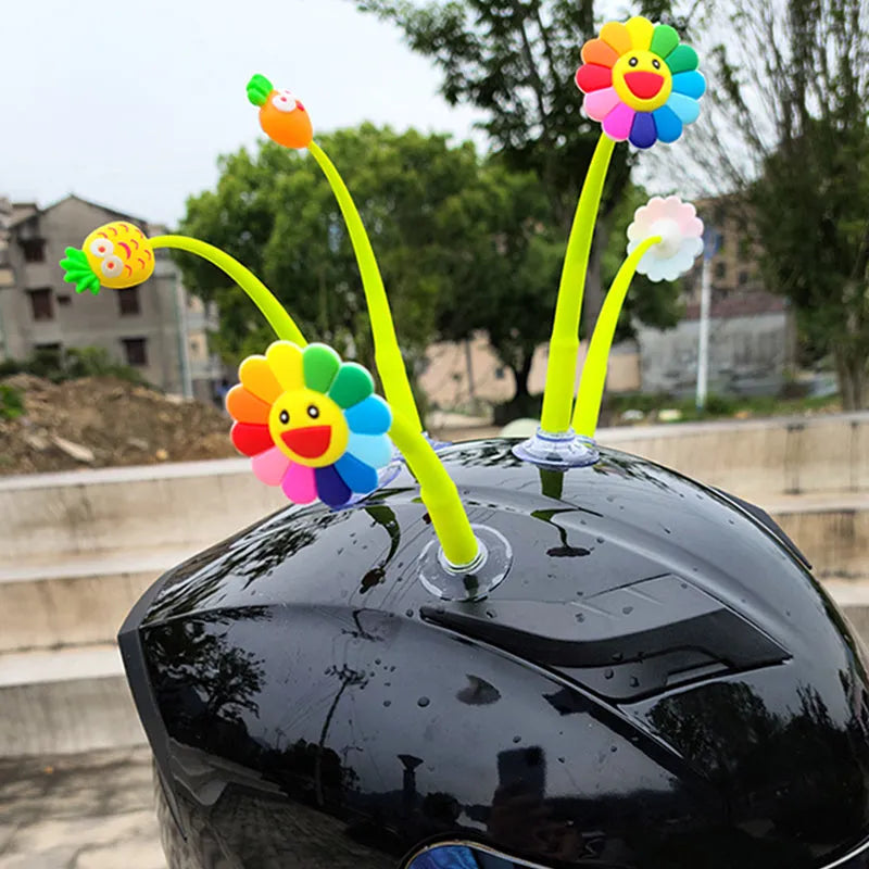 Yellow silicone sunflower helmet decoration with a brown centre and a clear suction cup for attachment.