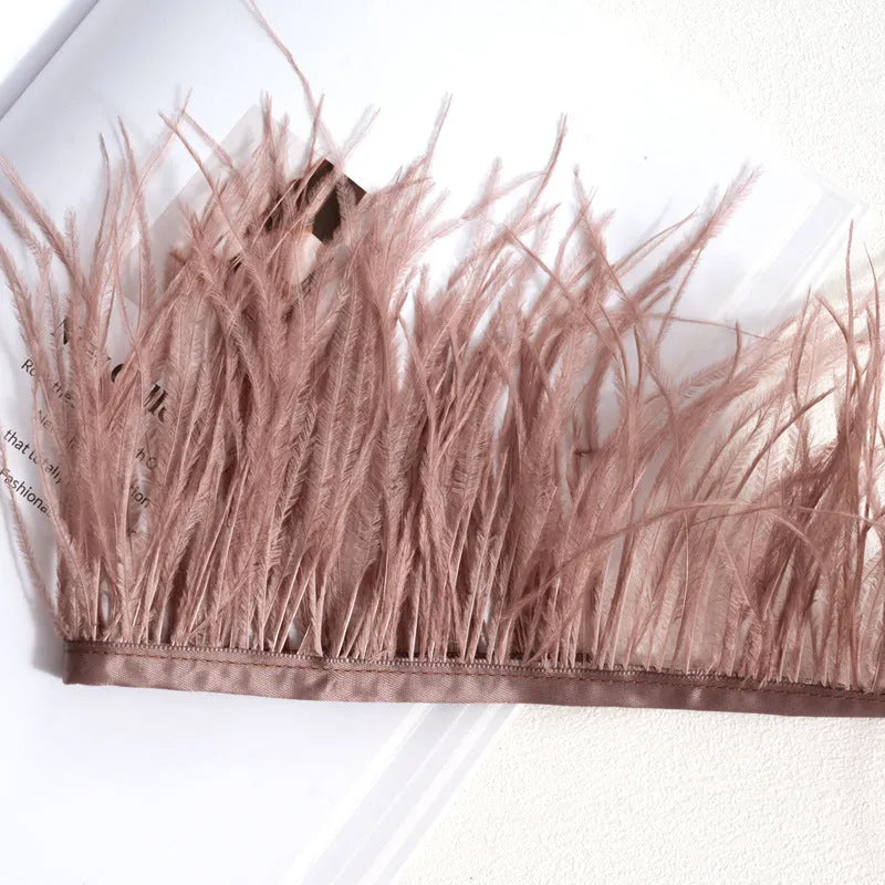 Decorative feather cloth strip in multiple colours including white, black, and mint green for DIY clothing and craft projects