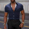 Man wearing a light blue short-sleeved casual shirt with a floral print, made from stretch polyester fabric.