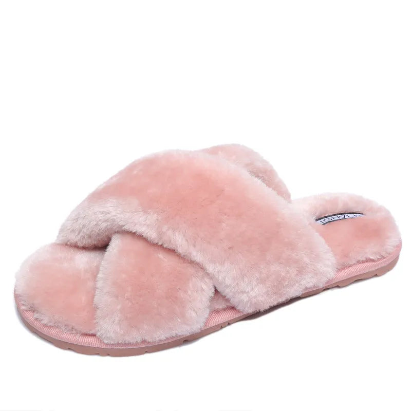 Women's black cross open-toe fur slippers on a white background, showing criss-cross upper and patterned sole.