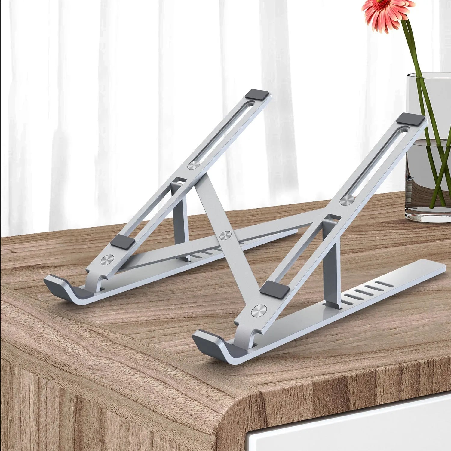 Silver aluminium laptop stand folded flat showing magnetic catch and adjustment gears