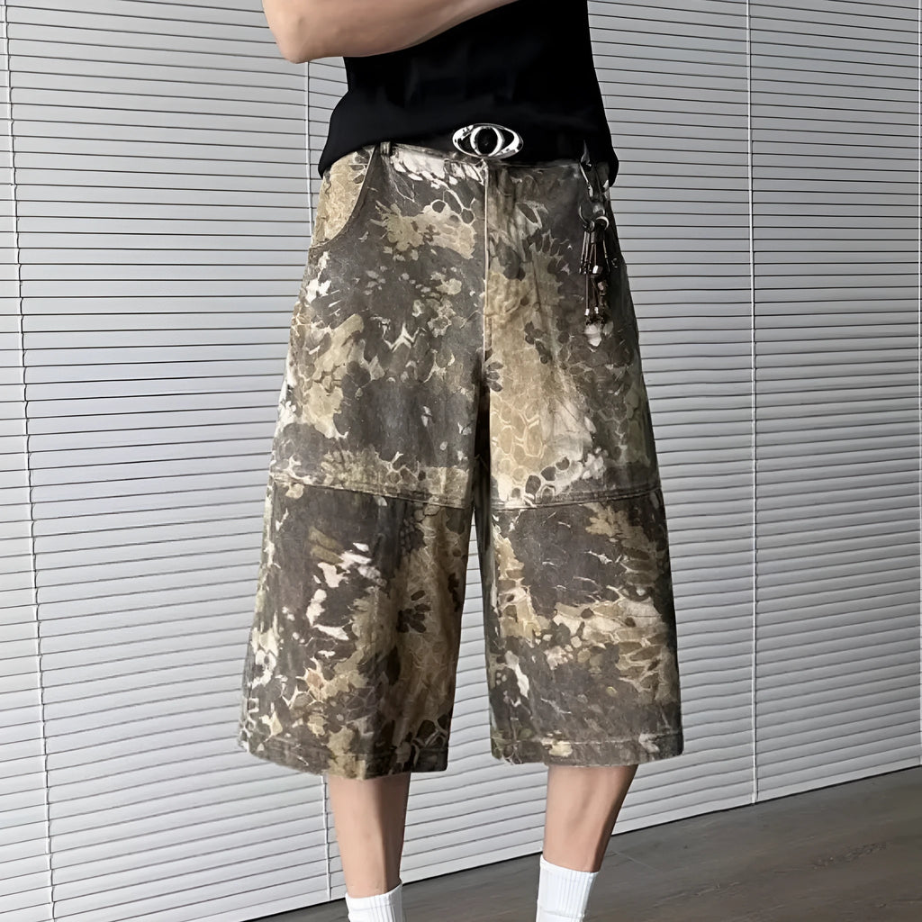 Yellow jeans with a snake camouflage pattern, shown in a cropped length.