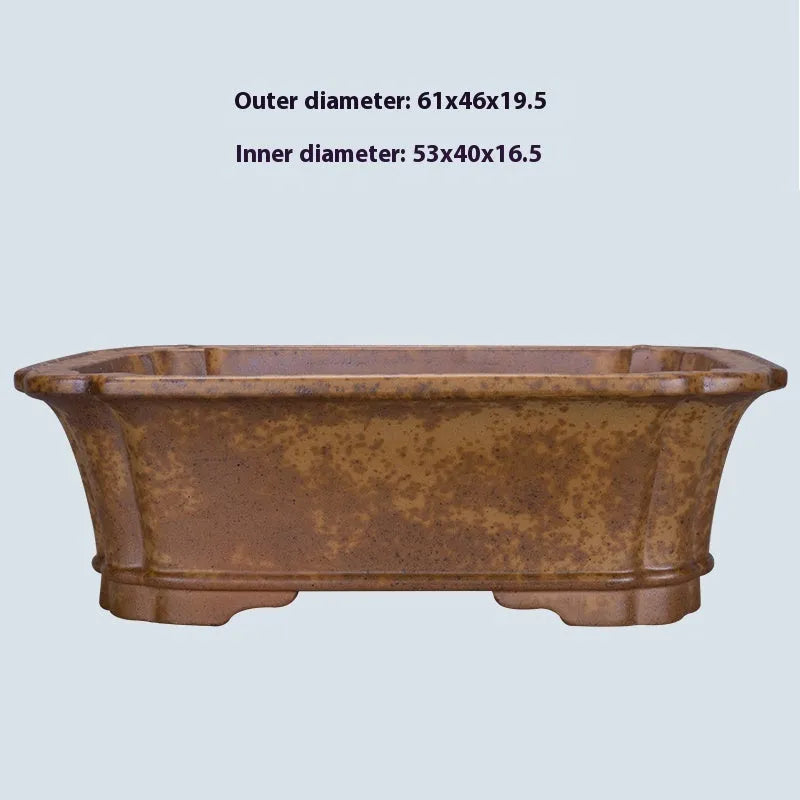 Large rectangular purple sand flowerpot with angled drainage base on a wooden patio.