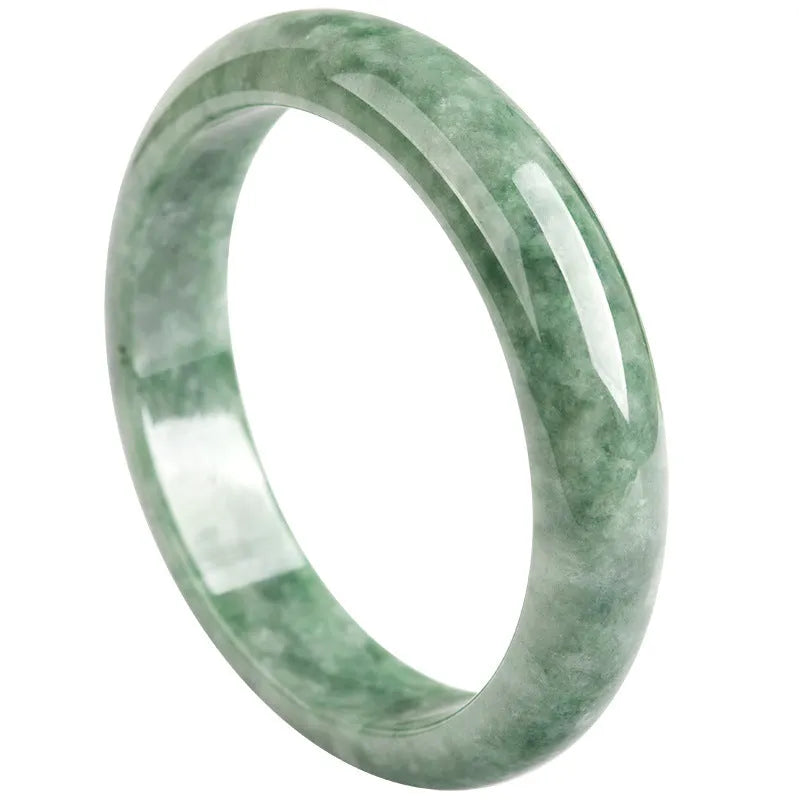 Natural emerald bean green women's bracelet on a gift box, showing simple design and deep pea green stone colour.