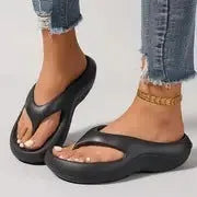 Women's thick-soled flip-flops in black, white and grey colours with non-slip EVA construction