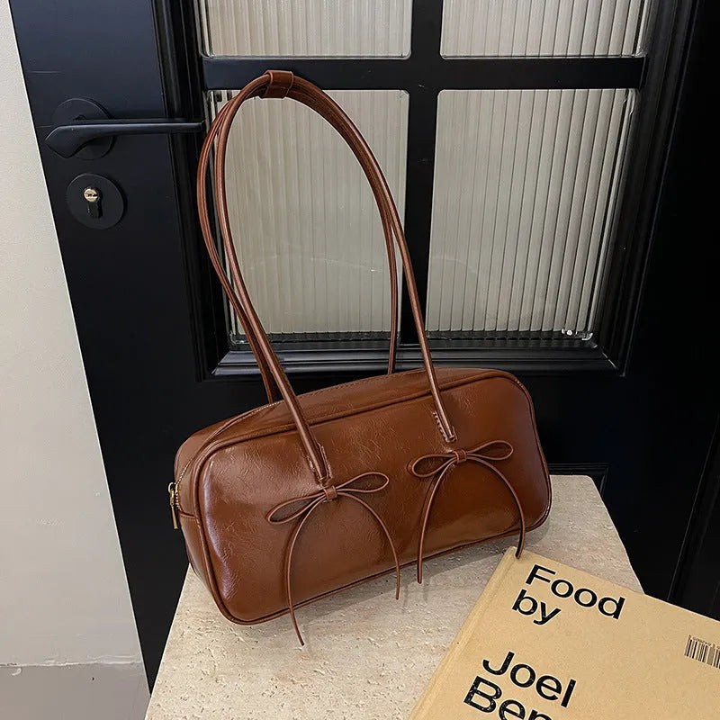 Soft PU pillow underarm bag in brown with bow, stitching and contrast colour details, large capacity women's daily matching bag