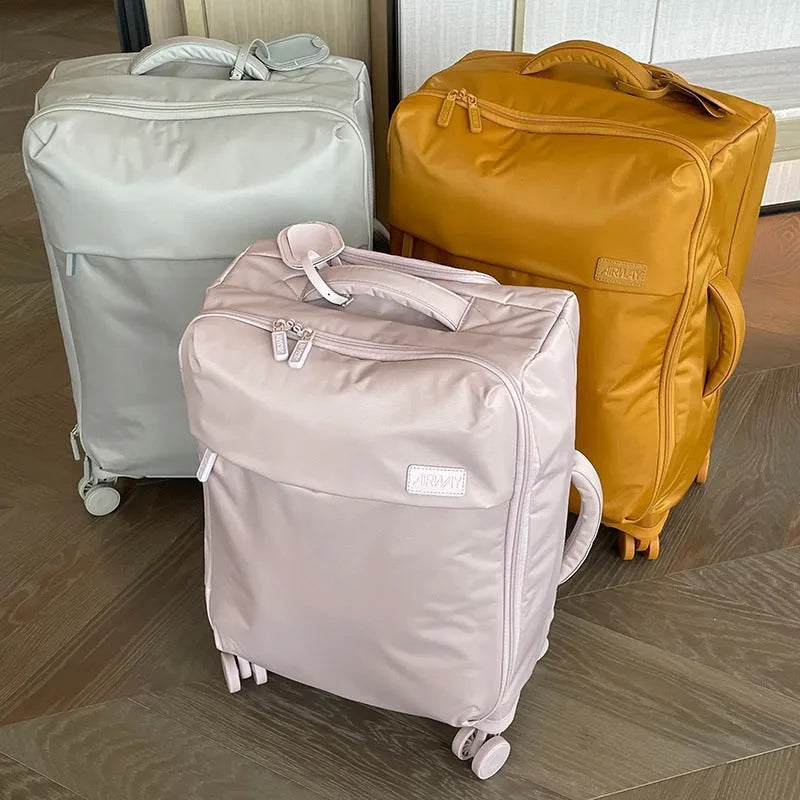 Ultra-light waterproof Oxford cloth suitcase in bluestone green with universal wheels, shown with a 24-inch size example.