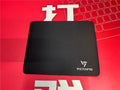 Black rough grain rubber desk mat for keyboard and mouse, shown on a desk