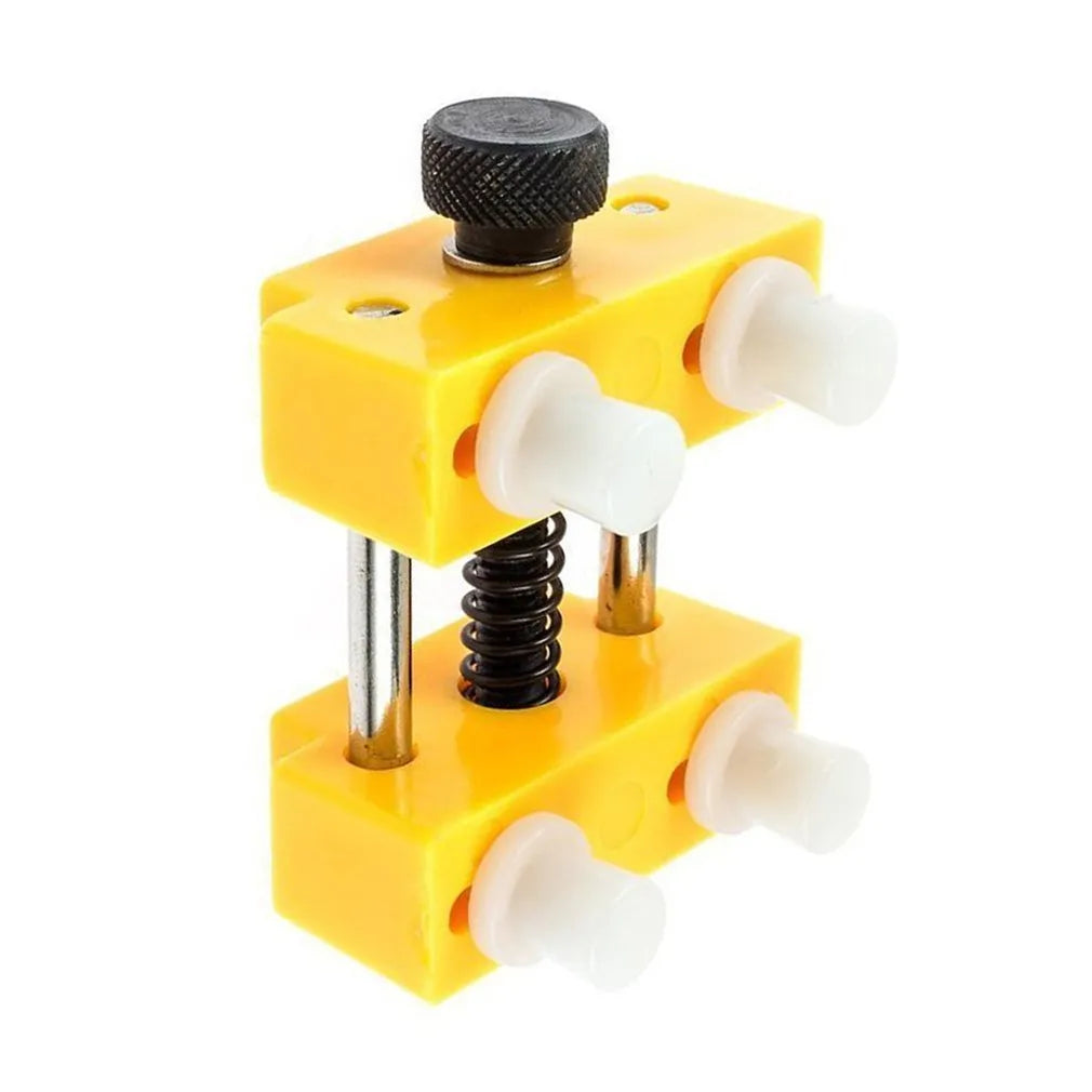 Yellow plastic watch case opener tool and fixing base with four pillars for DIY repair.