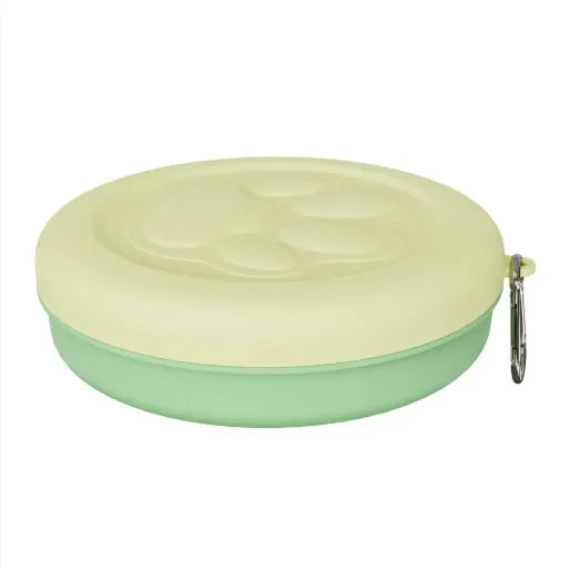 Collapsed and open views of a pink silicone dog bowl with matching sealing lid, next to a dog lead.