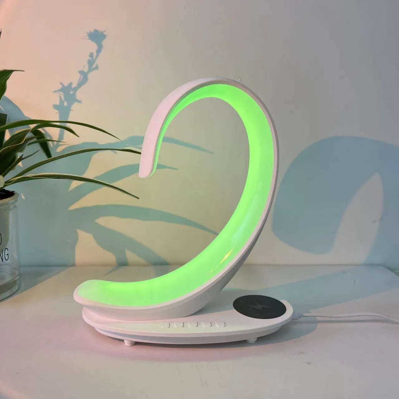 White swan-shaped desktop lamp with wireless charging pad and Bluetooth speaker functions, colourful LED lighting