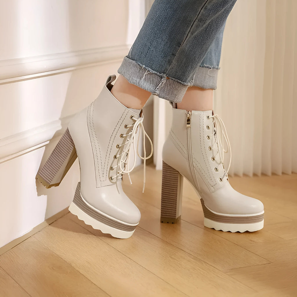Women's black chunky heel waterproof platform boots with a side zipper on a cowhide upper.