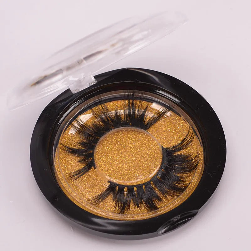 Hand-made 5D mink false eyelashes set with protective cap and dual-ended brush on a clean background