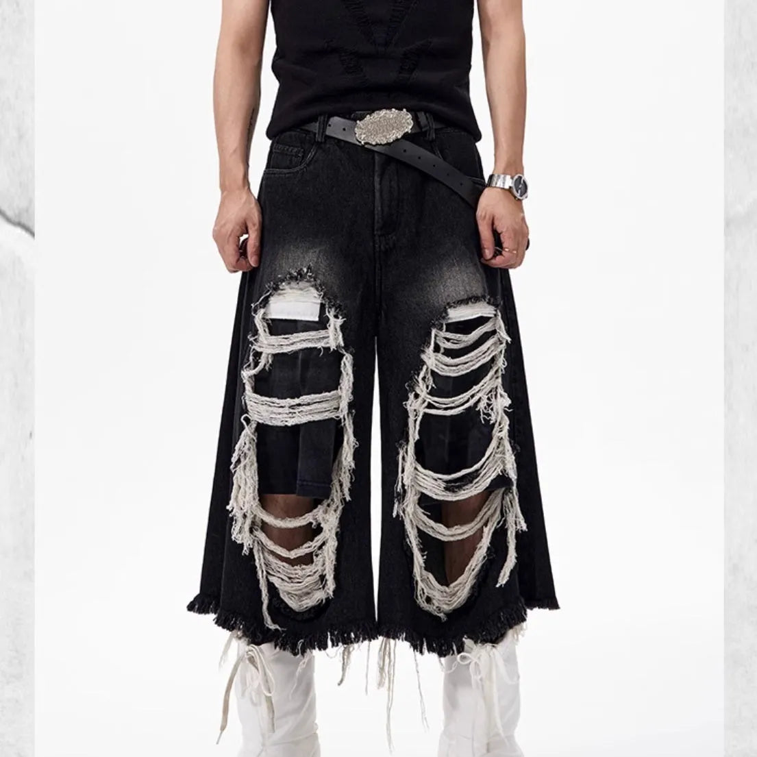 Black women's cropped wide-leg jeans with a mid-high waist and ripped patch details on a loose fit.