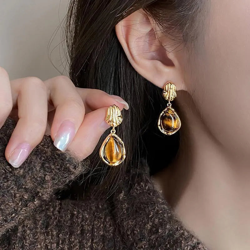Three pairs of handmade geometric alloy earrings with tassels in Maillard, Amber, and Tigereye styles.