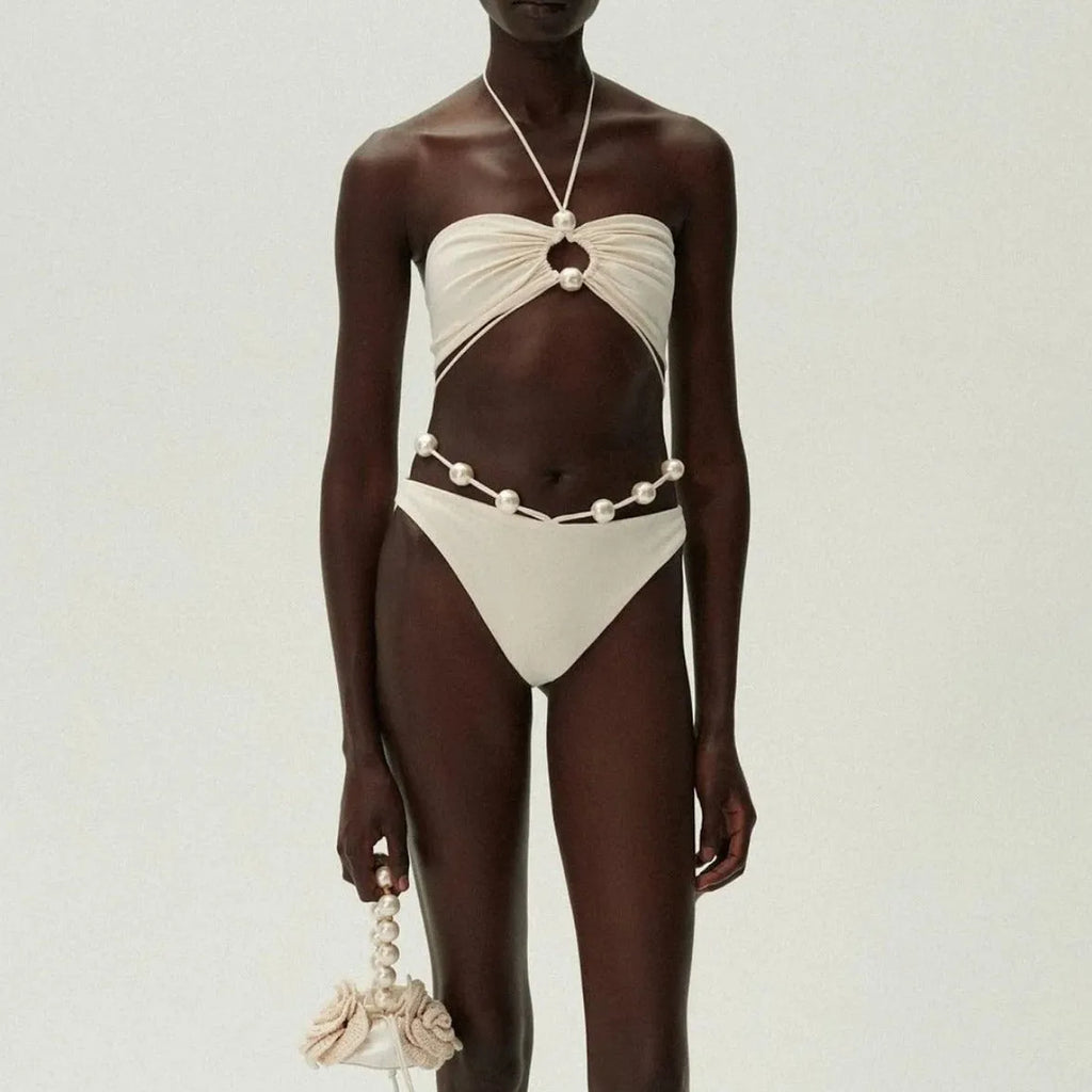 Black women's lace-up bikini swimsuit with separate bra and shorts pieces on mannequin