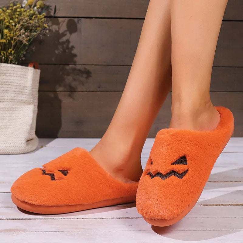 Orange women's Halloween pumpkin slippers with plush lining and a non-slip PVC sole