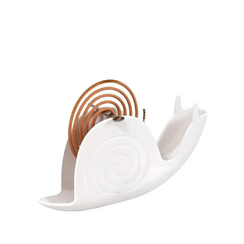 Black plastic universal mosquito incense holder on a table, simple portable design with creative animal style