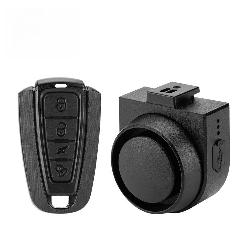 Black ABS rechargeable bicycle and motorcycle alarm with remote control and USB cable, showing compact unit and remote