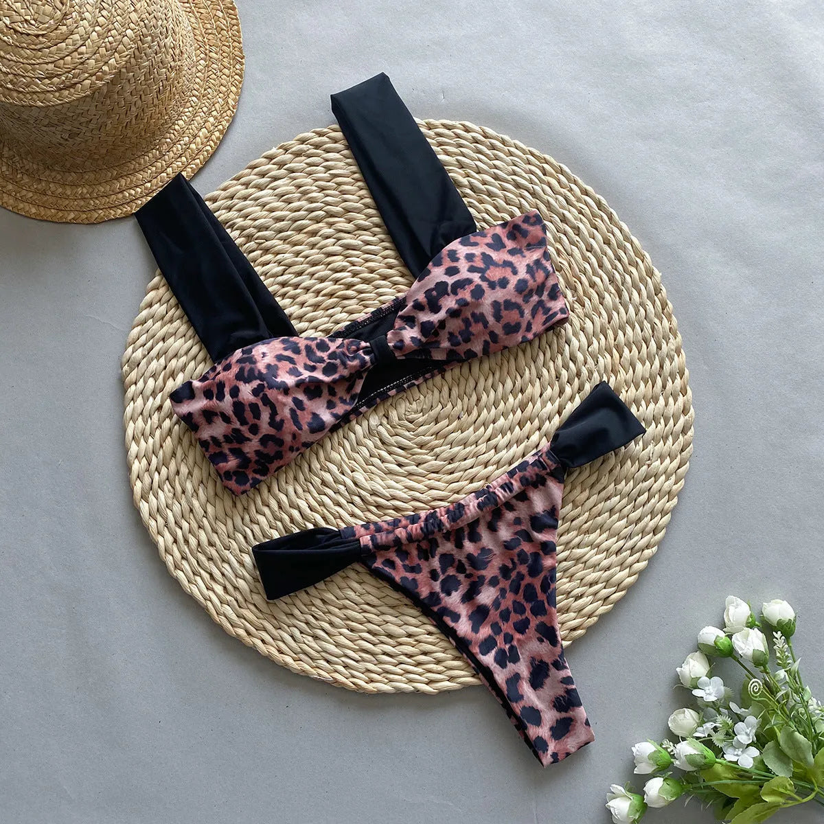 Women's leopard print bandeau bikini set with split top and T-pants bottoms.