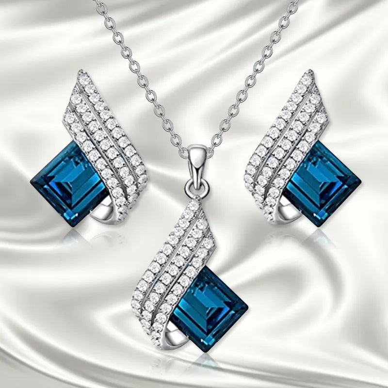 Women's electroplated alloy and glass jewellery set showing necklace with cross chain design and matching ear studs