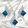 Women's electroplated alloy and glass jewellery set showing necklace with cross chain design and matching ear studs