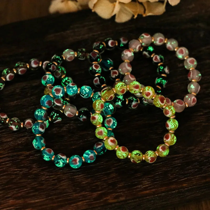 Handmade heart-shaped glass bead bracelet with ancient fluorescent glaze and swallowing gold beast design