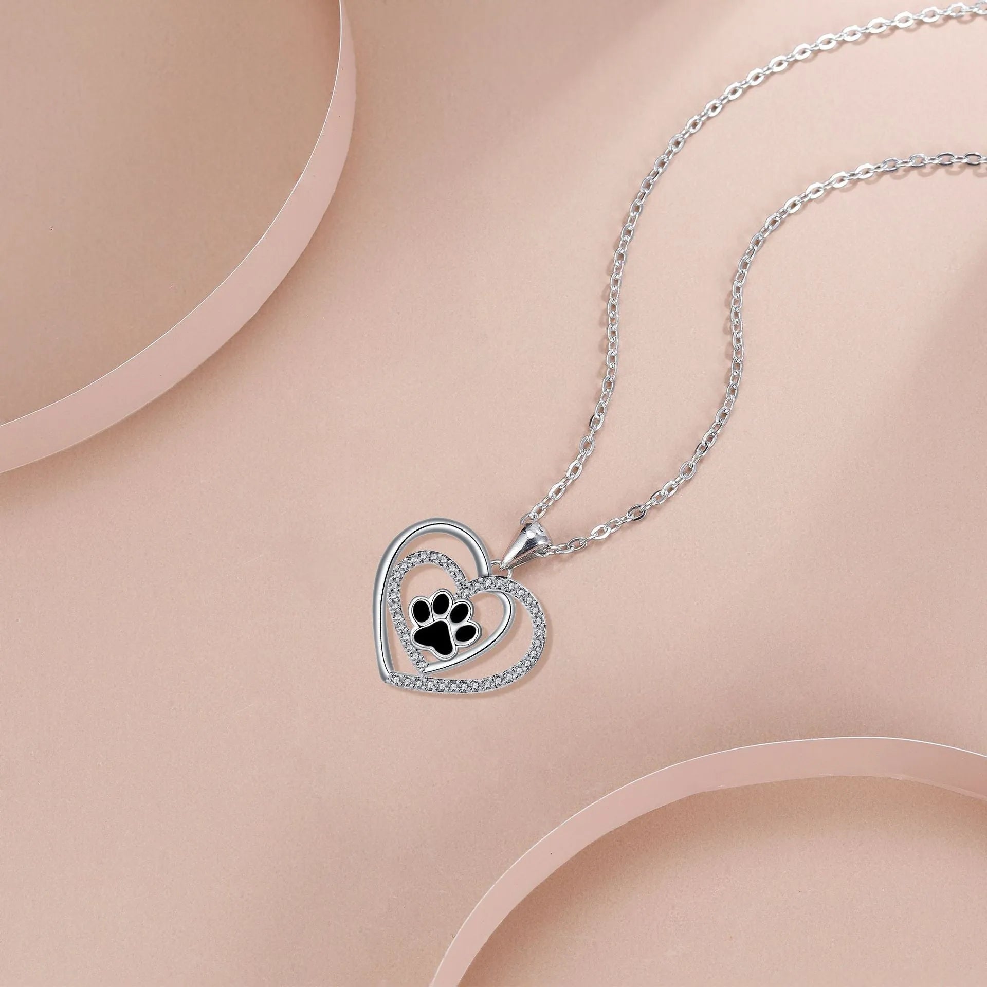 Women's copper necklace with dog paw print and heart pendant on cross chain