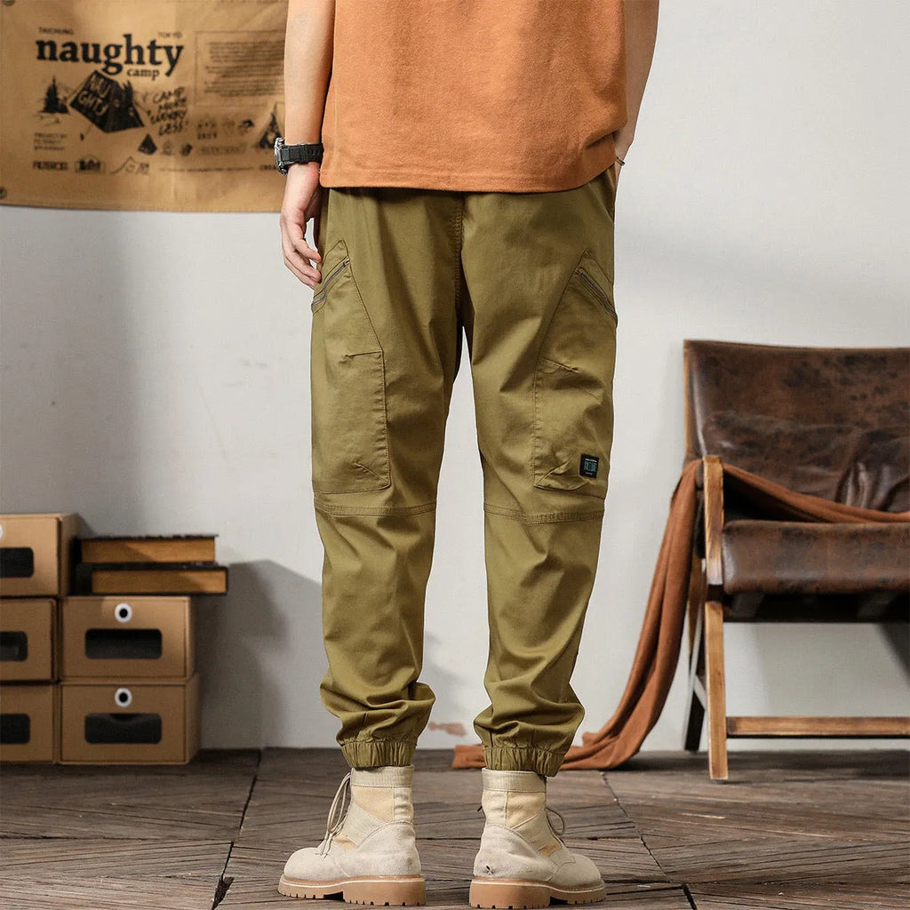 Men's cotton harem pants with tapered ankle cuffs in black colour showing loose fit and zip fly closure