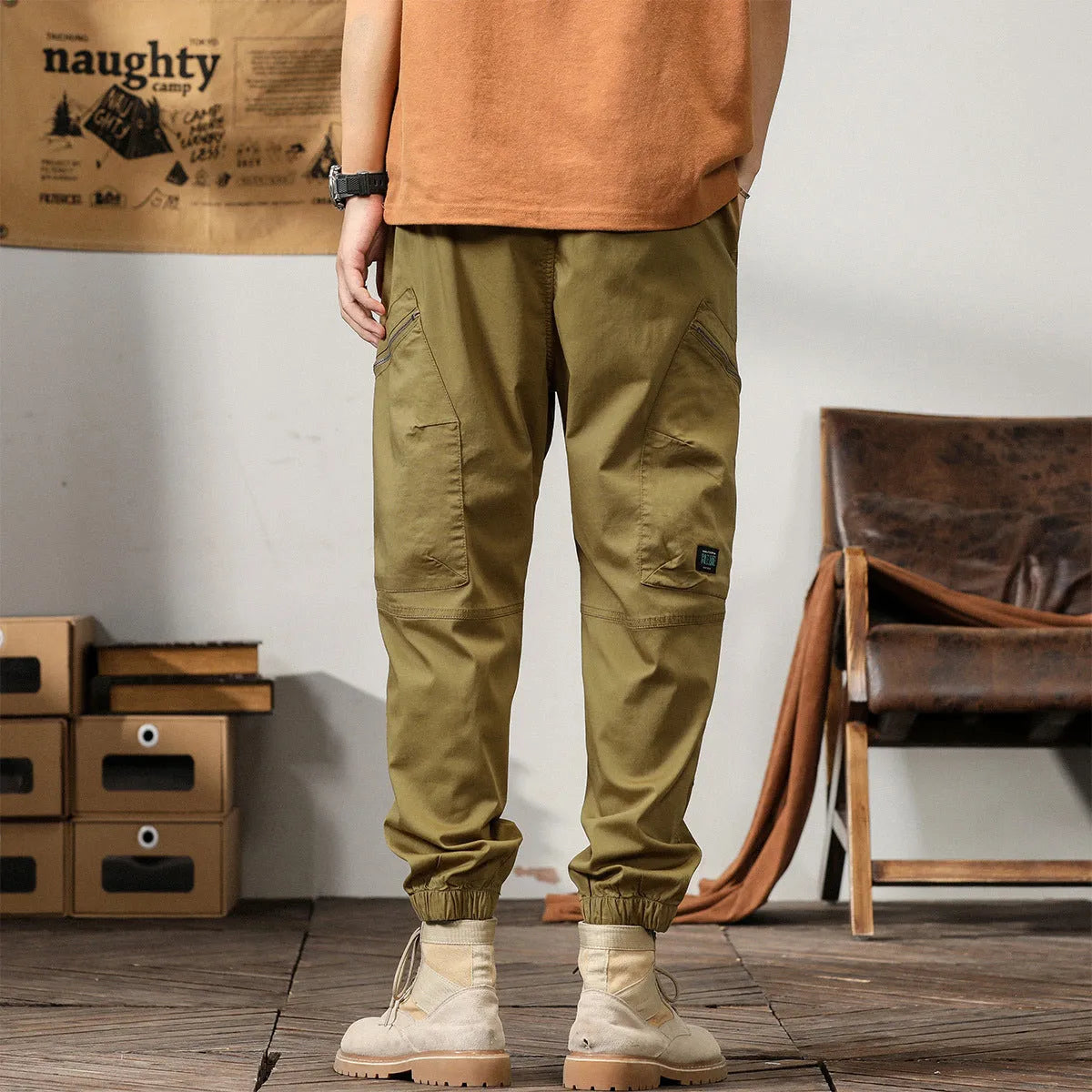 Men's cotton harem pants with tapered ankle cuffs in black colour showing loose fit and zip fly closure