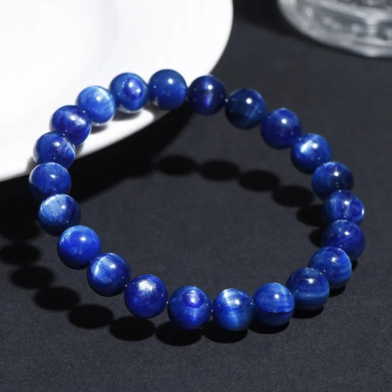 A polished blue crystal bracelet with geometry-shaped beads and a Ruyi charm on a single circle.