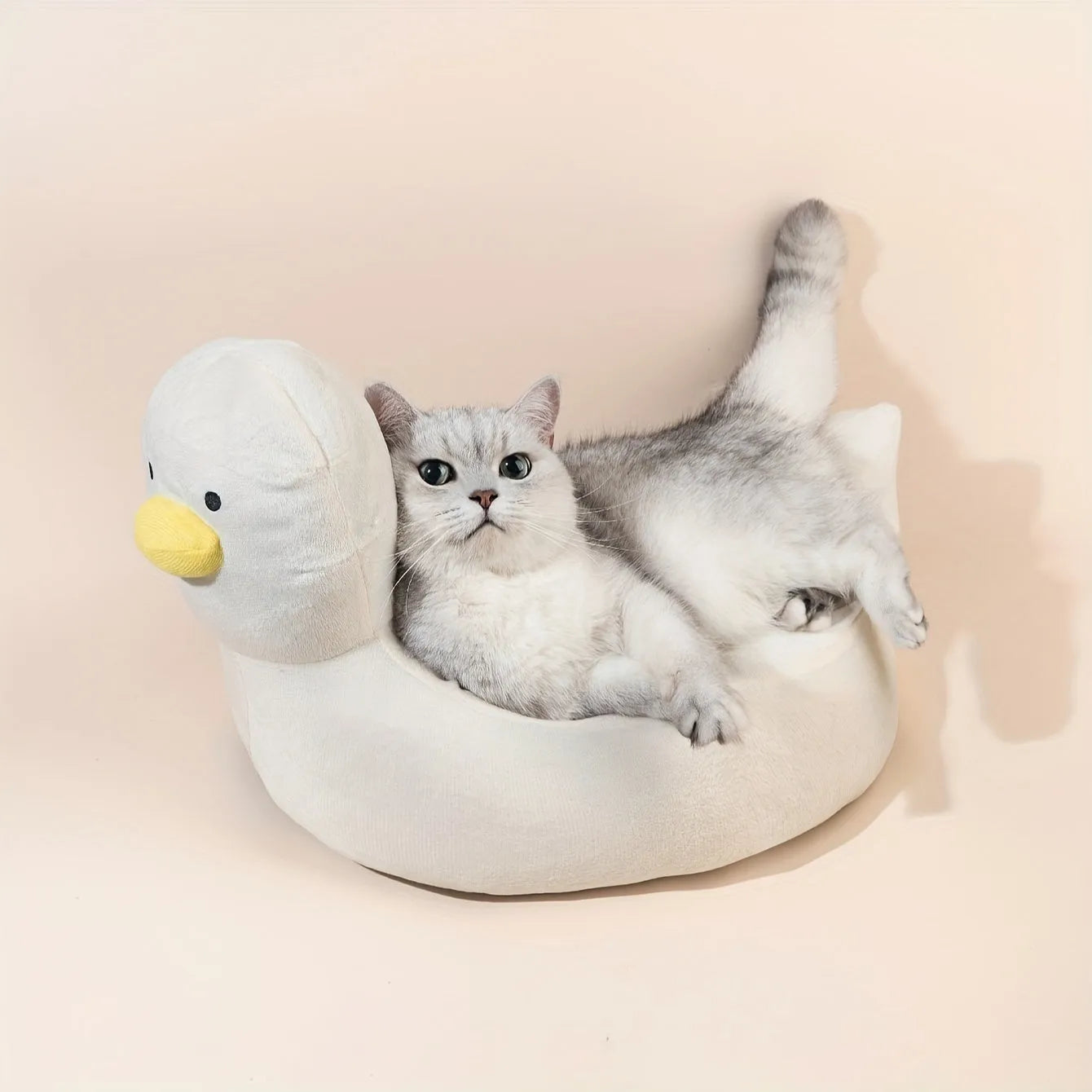 Blue duck-shaped fluffy pet bed for a small dog, showing raised rim and soft material.