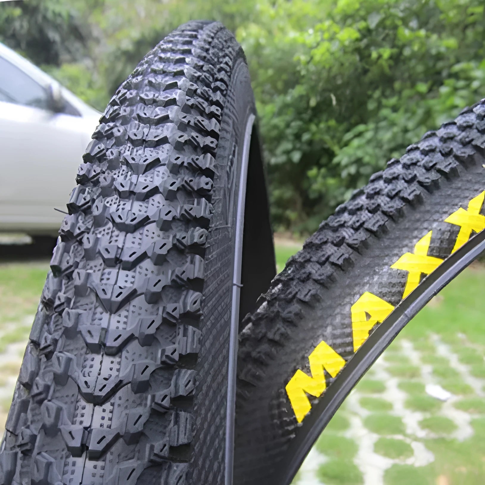 Mountain bike tyre with tread, shown in multiple size options: 26, 27.5 and 29 inch diameters.