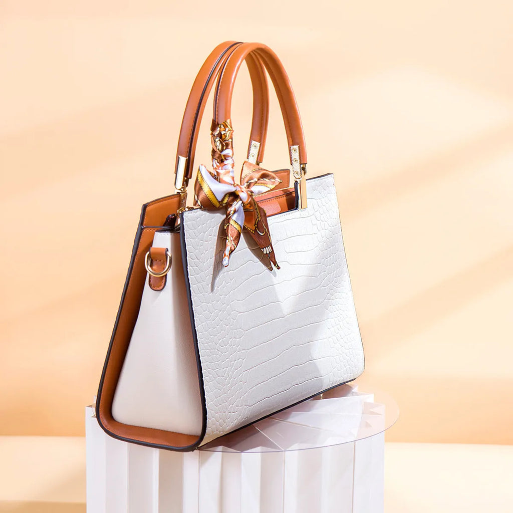 Milky white women's shoulder handbag with horizontal square shape showing internal organiser compartments