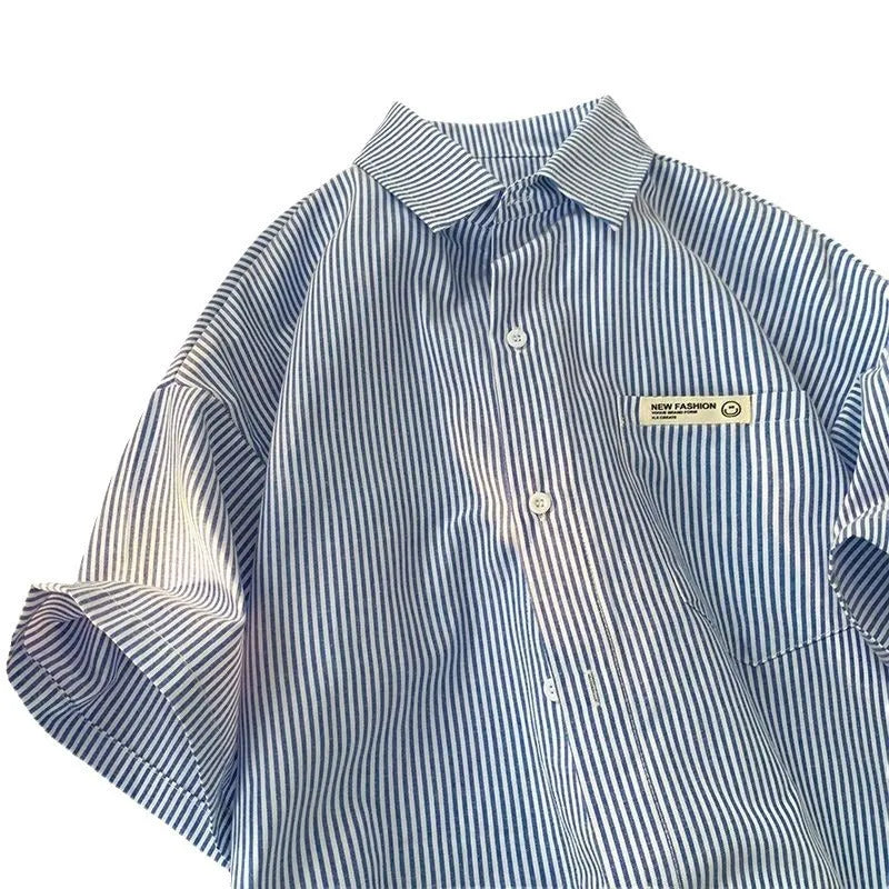 Blue and green striped loose fit plus size half sleeve shirt for women on a hanger