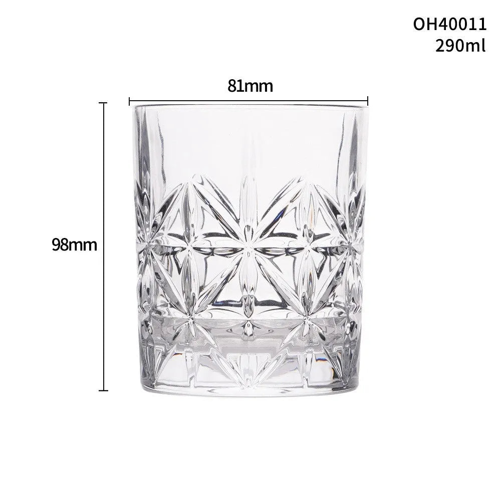 Clear crystal whiskey shot glass with thick bottom base on a table.