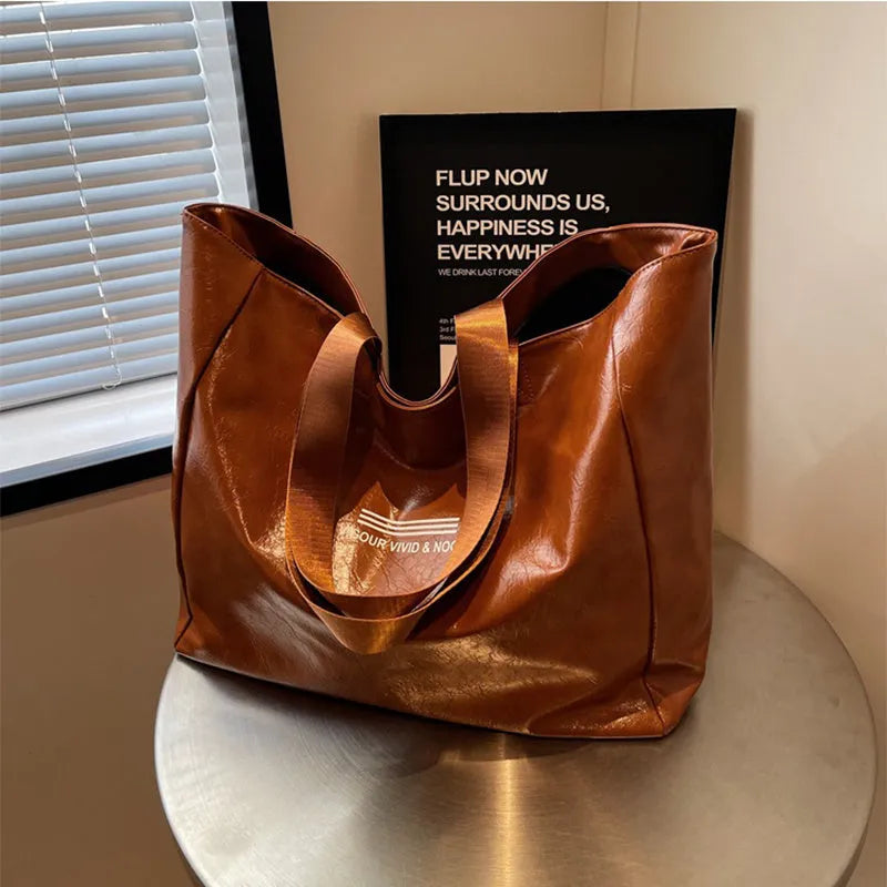 Large capacity PU tote bag for women in solid black, beige or brown, waterproof shoulder handbag for daily and travel use.