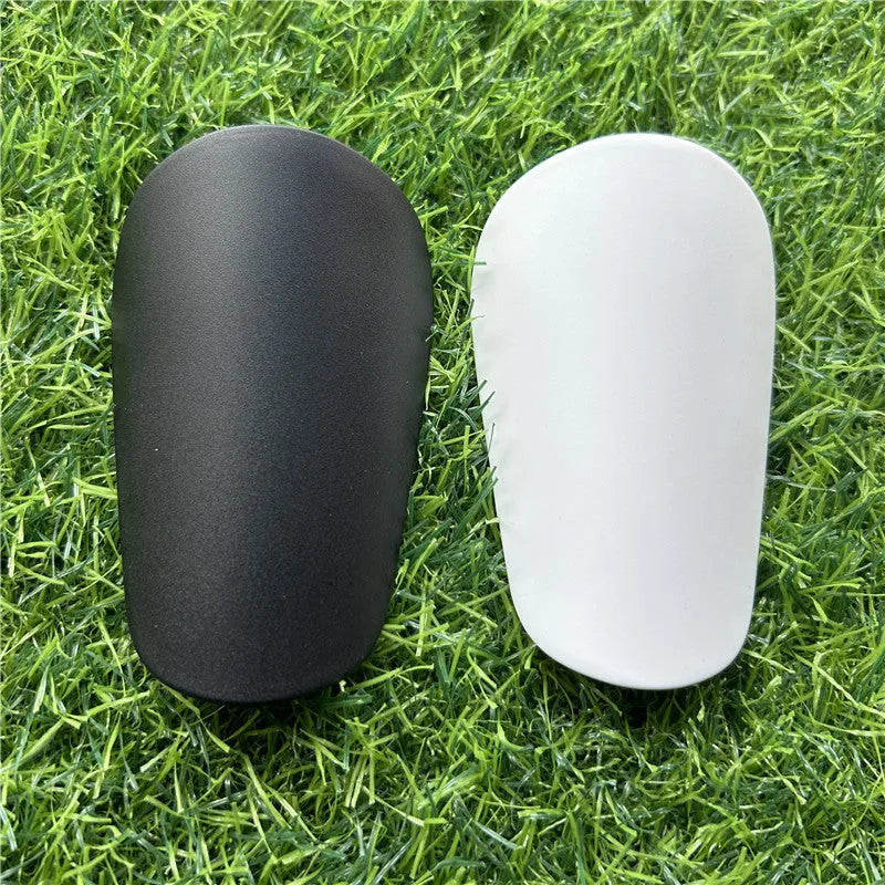 Extra small mini football shin guards in black and white plastic for youth players