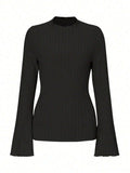 Long sleeve casual top in black with lantern sleeves and a sunken stripe pattern, laid flat.