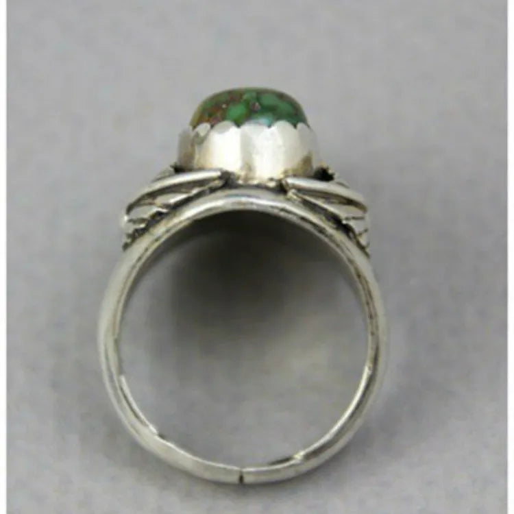 A geometric turquoise ring with a silver-toned alloy band and a retro design.
