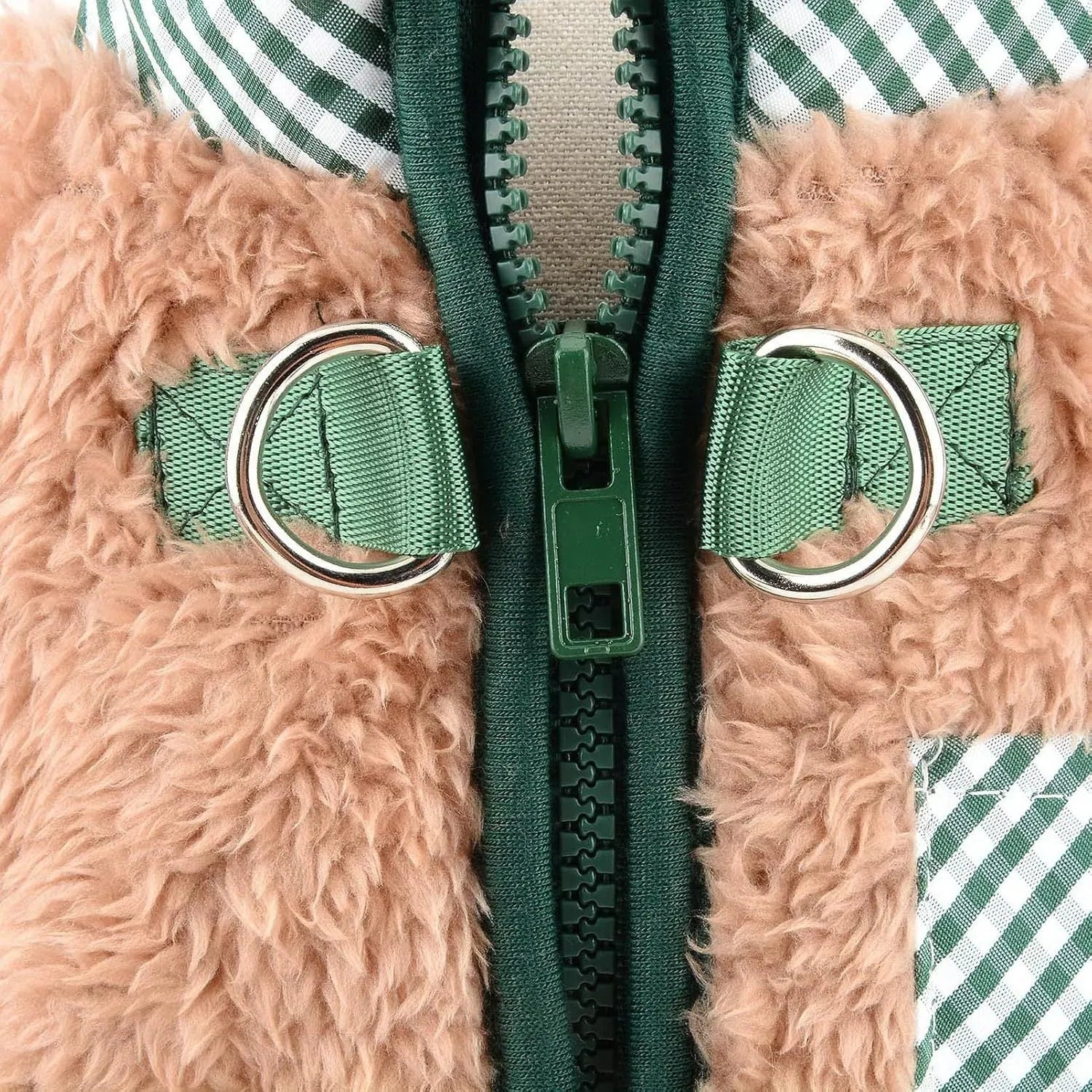 Small dog wearing green fleece coat with back zipper and D-rings, four-legged jumpsuit style