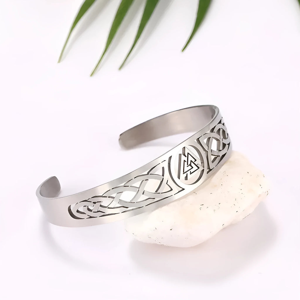 Handcrafted stainless steel bracelet with Valknut symbol and Celtic design on a neutral background