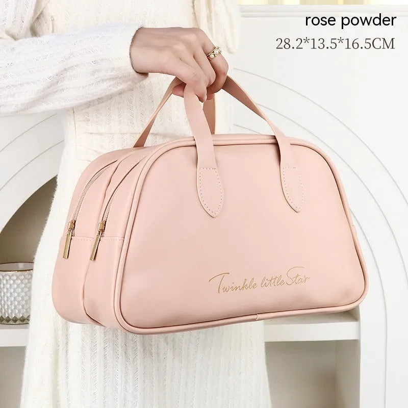 Large leather-look travel toiletry bag in caramel mocha colour with letter detailing, shown open.