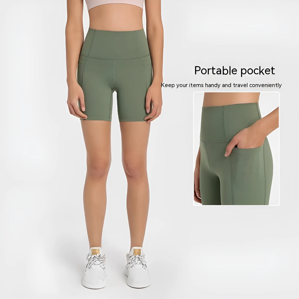 Women's solid colour mid-length sports shorts with a tight fit and waistband.