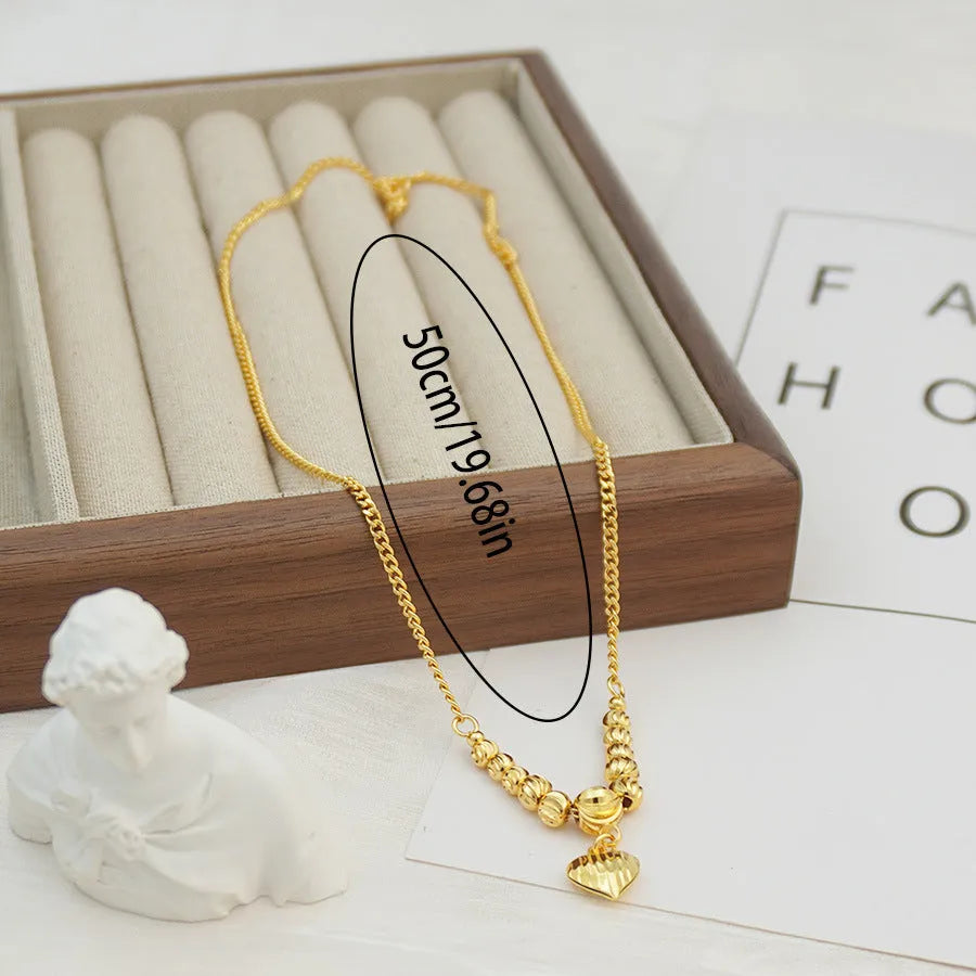 Copper heart necklace with electroplated finish, geometric shape, on white background
