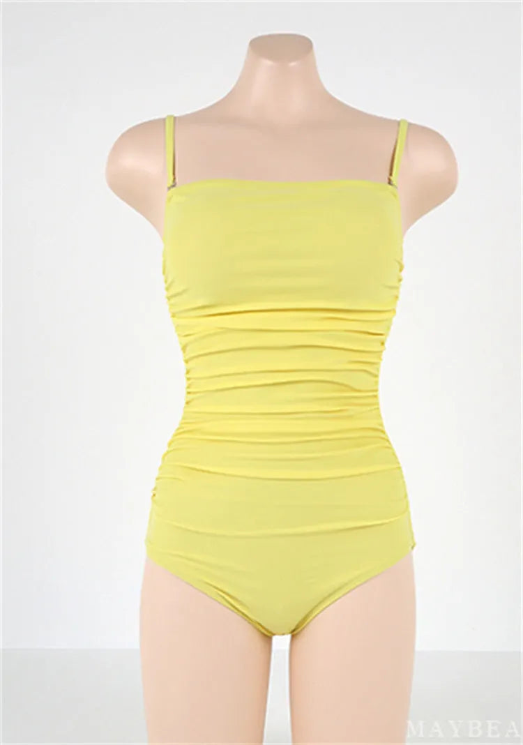 Blue one-piece sling style swimsuit with belly pleats and a slim-fit cut on a mannequin.