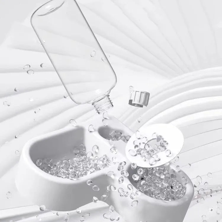 White plastic pet water fountain with electric pump on a floor.